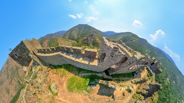 Panoramic aerial view of the medieval Maglic fortress, strategically positioned on a hilltop overlooking the meandering ibar river, showcasing its historical significance and stunning natural