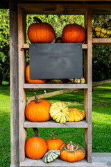 Halloween wall art mockup, frame with black board, wooden sign or chalkboard, pumpkin, paper decorations.