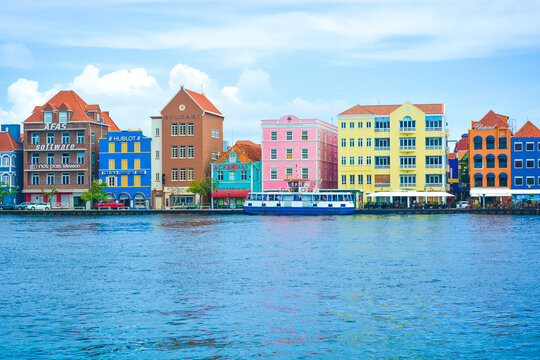 A  beautiful view on historic colourful buildings in central Willemstad in Cura&ccedil;ao. Taken from from Queen Emma floating bridge. 