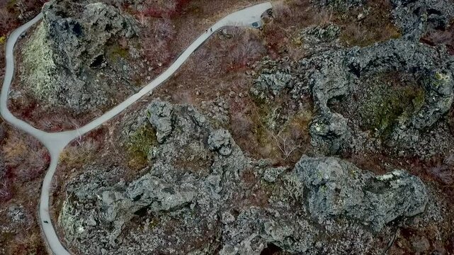 Camera slowly panning across the striking volcanic formations of Dimmuborgir in Iceland from above, revealing the breathtaking landscape and unique geological features