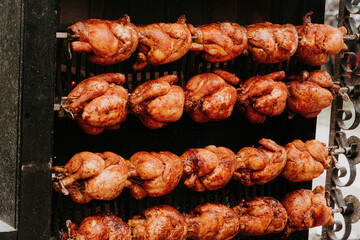 Multiple Roasted Chickens Slowly Turning On Outdoor Rotisserie
