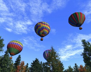 Fototapeta premium Colorful hot air balloons soaring over a lush green forest under a clear blue sky.