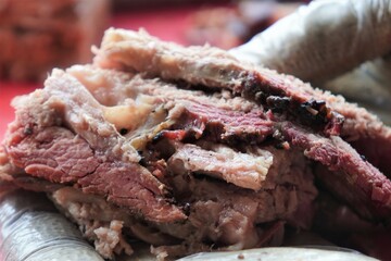 Smoked beef brisket fresh out of the smoker and sliced for serving.   Juicy and delicious, BBQ beef brisket for family cook out.