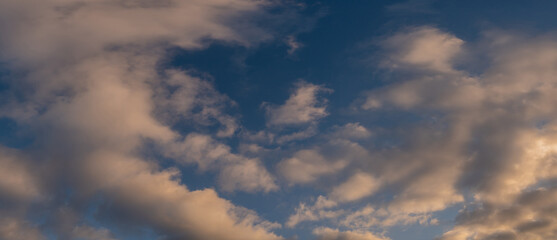 Cloudy sky at sunset or sunrise. Dramatic panoramic skyscape. Panorama nature background.