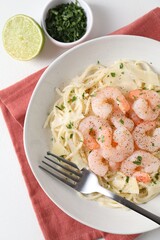 Delicious pasta with shrimps and cheese served on white table, top view