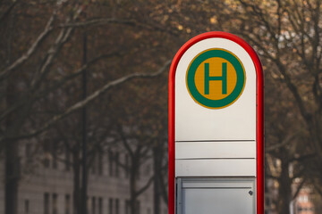 Selective blur on a typical austrian and german bus stop sign, called haltestelle, or bushaltestelle, in a dortmund urban environment. it indicates the presence of a public transportation stop station © Jerome