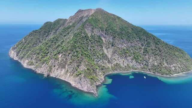 The scenic island of Komba lies about 70 km north of the island of Lembata in the Lesser Sunda Islands of Indonesia. This remote island, surrounded by reef, is an active volcano that often erupts.