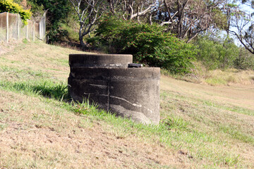 Old concrete tank on a grassy slope