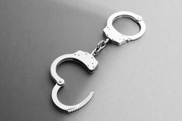 New classic chain handcuffs on grey background