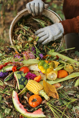 Zero waste, compost. Compost heap pile with bio waste. Farmer hands put weeds grass plants,...