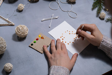 Christmas wreath Storytelling of creating craft Christmas greeting card holiday present. Tactile hand-on activity. Master class progress of creative me-made gifts. Seasonal domestic life micro moment