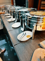 In the buffet area of the hotel, you'll find several consecutive food warming machines.