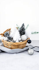 wicker basket filled with miniature trees ornaments