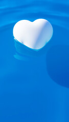 white heart floats on a blue surface