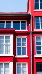 Obraz premium bright red building with white-framed windows