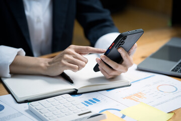Close up of hands typing and working  on smartphone, and using smartphone for shopping online and social networks for relax after work.