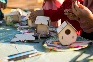 Kids hands making wooden toy house. hobby or leisure. DIY wooden house project.