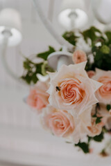 This image features an exquisite closeup view of a beautiful bouquet of pink roses arranged elegantly on a table surface