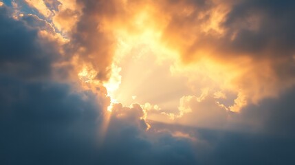 A cloudy sky at sunset, with the sun peeking through the clouds and casting a warm glow