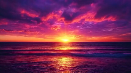 Obraz premium A stunning sunset with vibrant orange, pink, and purple hues filling the sky above a calm horizon