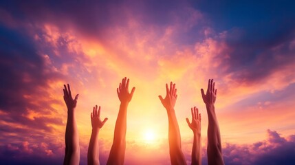 Uplifted hands against a vibrant sunset sky