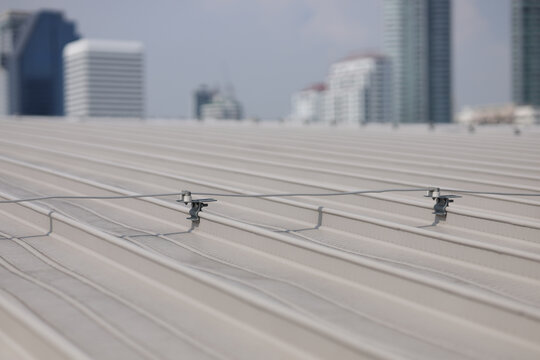 Bare aluminum tape installed on the roof. Lightning protection system installed on the roof of high-rise building. 
