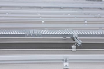 The connection point between two walkways is connected with a splice set and nuts. Metal walkway installed on the roof.