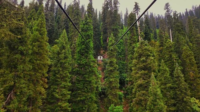 Cable car in a dense mountain forest on a cloudy day in Arang Kel village in Azad Kashmir, Pakistan