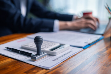 Man carefully reviewed finance agreements and contract documents with his client, discussing loan,...