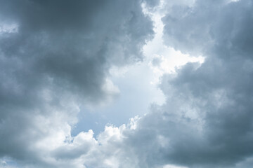 Fototapeta premium Dramatic timelapse of white clouds racing across a blue sky, casting dark shadows on the landscape
