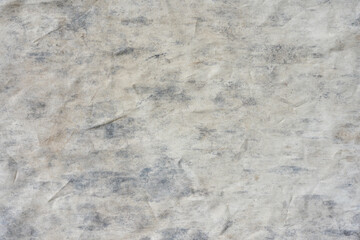 Grungy aged stone wall with textured paper wallpaper pattern, dirty and rough, in a vintage grey and brown color