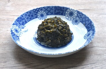 stir fried pickled mustard or Gan Lan Cai Chinese food made from cabbage and black olive in oil on plate 