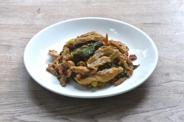 spicy stir fried chop gluten protein with basil dressing slice chili vegetarian fusion food on plate