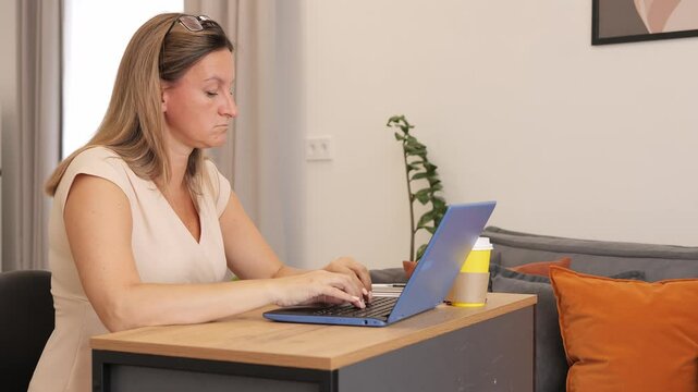 Woman is focused on her work her concentration is visible in every keystroke Ideal shots for themes such as productivity concentration during tasks, and dedication tu work highlight deep concentration