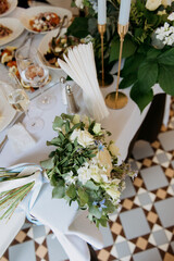 A beautifully arranged table adorned with a stunning bouquet of vibrant flowers alongside...