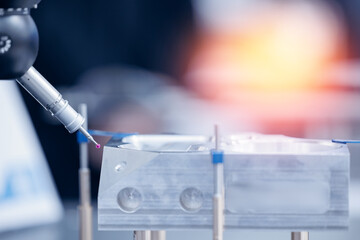 Quality control of drilling CMM in car engine. Milling CNC machinery with coordinate measuring machine for automotive parts industrial