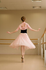 Ballet dancer performing pirouette en pointe © Vagengeim