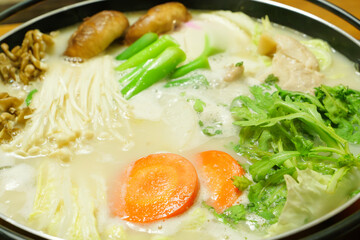 Soy milk nabe, a Japanese home-style dish of carrots, Chinese cabbage, mushrooms, and meat simmered in a pot with soy milk