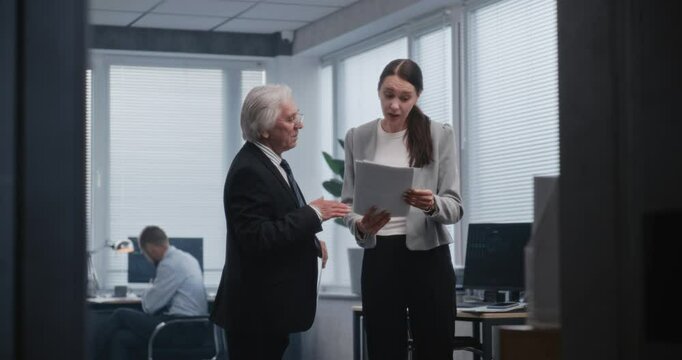 Teamwork in financial department of international corporation. Diverse colleagues discuss results of purchase, sale transactions and profitable strategy for trading company. Work in modern office.