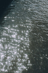 This is a closeup view of a shimmering body of water, with bright sunlight reflecting beautifully on its surface