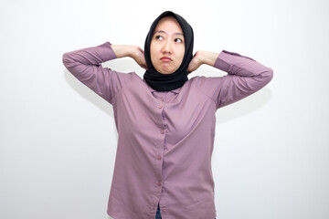 portrait of Asian, Indonesian woman wearing shirt and hijab yawning and stretching her hands. Lazy woman who looks sleepy, bored and tired. Isolated on white background