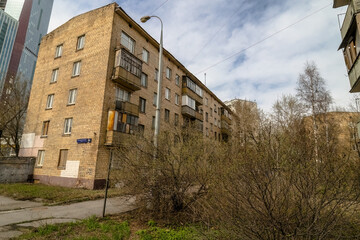 Fototapeta premium Brick old building with balconies in Russia, Soviet architecture house