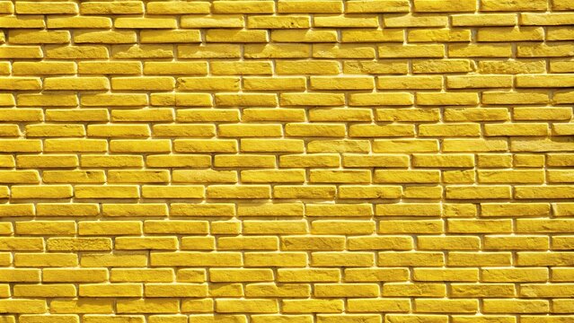 Yellow brick wall background with asymmetrical picture frame