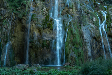 Beauty Waterfall in the Plitvice Lakes in Croatia. The waterfalls in forest. Summer view of beautiful waterfalls and clear lake. Plitvice Lakes National Park, Croatia. Summer nature landscape.