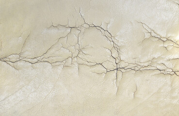 damage beige skin leather couch seat with cracks textured for background