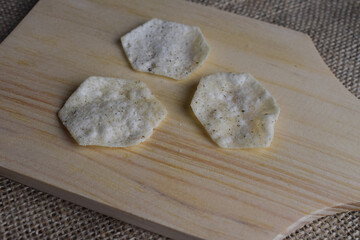 Potato chips on wooden cutting board