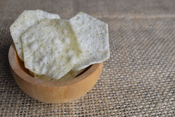 Potato chips in a wooden bowl