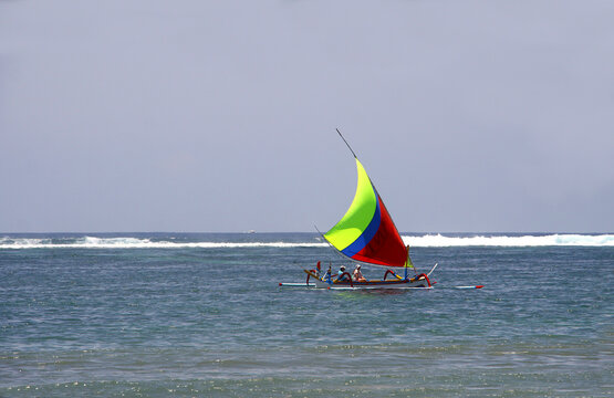 Jukung Sailboat passing by at Sanur Beach in Bali, Indonesia