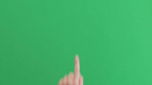 Young female hand touch gestures over green background
