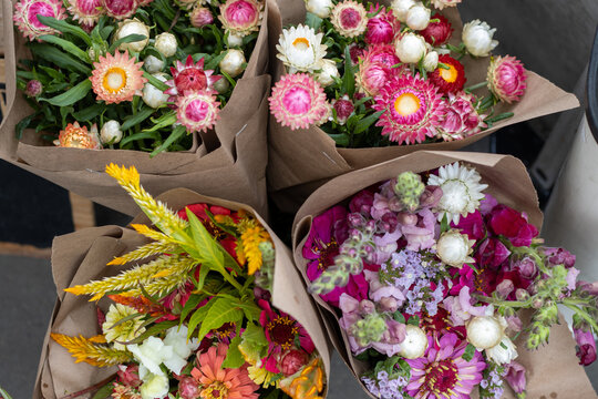 Colorful flower bouquets for sale at a farmers market stand